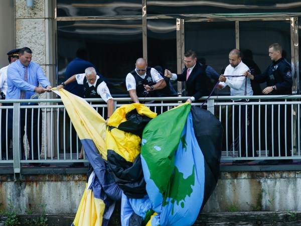 A giant banner from Greenpeace is pulled out of the Chicago River after hanging on the side of Trump Tower in Chicago on Friday, July 7, 2017. (Jose M. Osorio/Chicago Tribune)