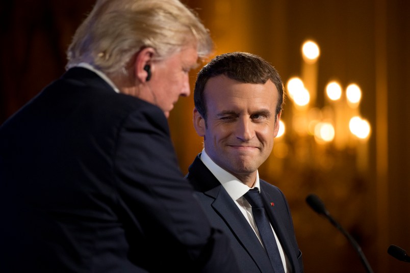 French President Emmanuel Macron winks at President Donald Trump during a joint news conference at the Elysee Palace in Paris, Thursday, July 13, 2017. (AP Photo/Carolyn Kaster)