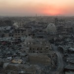 In this July 11, 2017 , the sun sets behind destroyed homes and buildings on the west side of Mosul, Iraq. (AP Photo/Felipe Dana)