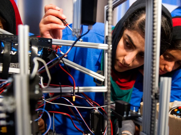 Afghanistan team member Lisa Azizi trouble shoots the teams robot entry prior to the opening ceremony for the FIRST Global Challenge 2017, in Washington, Sunday, July 16, 2017. They will be competing against entrants from more than 150 countries in the FIRST Global Challenge. It’s the first annual robotics competition designed to encourage youths to pursue careers in math and science. (AP Photo/Cliff Owen)