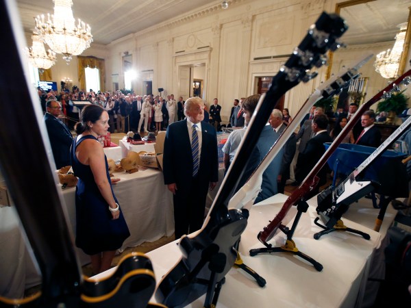 President Donald Trump, second from left, looks at Gibson Guitars, made in Tennessee,  during a "Made in America," product showcase featuring items created in each of the U.S. 50 states, at the White House, Monday, July 17, 2017, in Washington. (AP Photo/Alex Brandon)