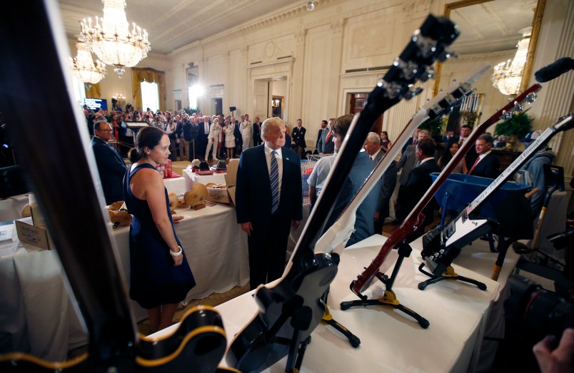 President Donald Trump, second from left, looks at Gibson Guitars, made in Tennessee,  during a "Made in America," product showcase featuring items created in each of the U.S. 50 states, at the White House, Monday, July 17, 2017, in Washington. (AP Photo/Alex Brandon)