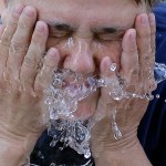 Terri Patterson cools off at a water fountain in Liberty Park Wednesday, June 21, 2017, in Salt Lake City. The National Weather Service is warning those hiking or spending time outside in southern Utah this week that temperatures could reach dangerously high levels. Very hot temperatures will continue for one more day across northern Utah. (AP Photo/Rick Bowmer)