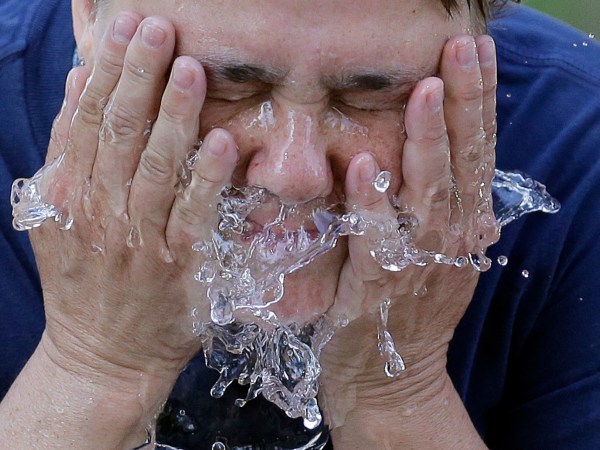 Terri Patterson cools off at a water fountain in Liberty Park Wednesday, June 21, 2017, in Salt Lake City. The National Weather Service is warning those hiking or spending time outside in southern Utah this week that temperatures could reach dangerously high levels. Very hot temperatures will continue for one more day across northern Utah. (AP Photo/Rick Bowmer)