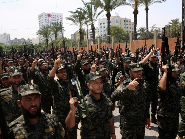 Officers from Hamas national security force chant Islamic slogans while holding their rifles up during a parade against Israeli arrangements in the contested Jerusalem shrine, in front of the Palestinian Legislative Council in Gaza City, Wednesday, July 26, 2017. A senior Muslim official in Jerusalem said Wednesday that worshippers would not return to the contested shrine until Israel removes the new railings and cameras it installed after a deadly attack there. (AP Photo/Adel Hana)