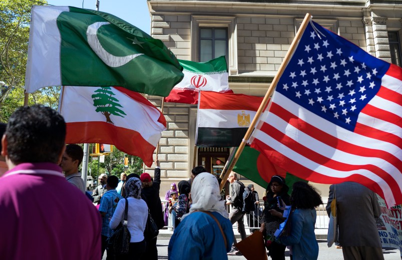 Marchers carry the national flags of Pakistan, top left, Lebanon, bottom left, Iran, top center, Egypt, bottom center and the American flag, right, during the Muslim Day Parade on Madison Ave. Sunday, Sept. 25 2016, in New York. (AP Photo/Craig Ruttle)