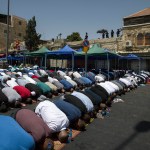 Palestinians pray outside the Damascus Gate in Jerusalem's Old City Friday, July 28, 2017. Muslim prayers at a major Jerusalem shrine ended peacefully Israeli police said Friday but violence continued in the West Bank where a Palestinian was killed attacking soldiers as forces were on high alert following two weeks of violence over the sacred site, holy to both Muslims and Jews. (AP Photo/Tsafrir Abayov)