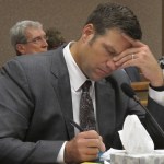 Kansas Secretary of State Kris Kobach listens and takes note as a judge declares in Shawnee County District Court that the state must count potentially thousands of votes from people who registered without providing documentation of their U.S. citizenship, Friday, July 29, 2016, in Topeka, Kan. Kobach had directed local election officials to count only their votes in federal races, not state and local ones. (AP Photo/John Hanna)
