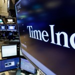 The Time Inc. logo appears above a trading post on the floor of the New York Stock Exchange, Thursday, June 15, 2017. Magazine publisher Time Inc. says it's cutting 300 jobs as it struggles to adjust to readers' shift online. (AP Photo/Richard Drew)