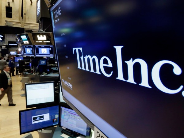 The Time Inc. logo appears above a trading post on the floor of the New York Stock Exchange, Thursday, June 15, 2017. Magazine publisher Time Inc. says it's cutting 300 jobs as it struggles to adjust to readers' shift online. (AP Photo/Richard Drew)