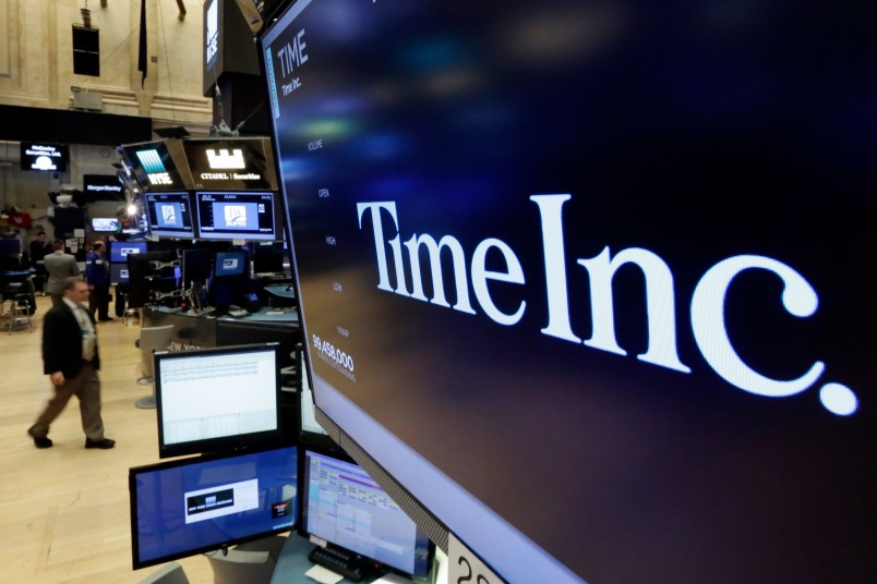 The Time Inc. logo appears above a trading post on the floor of the New York Stock Exchange, Thursday, June 15, 2017. Magazine publisher Time Inc. says it's cutting 300 jobs as it struggles to adjust to readers' shift online. (AP Photo/Richard Drew)