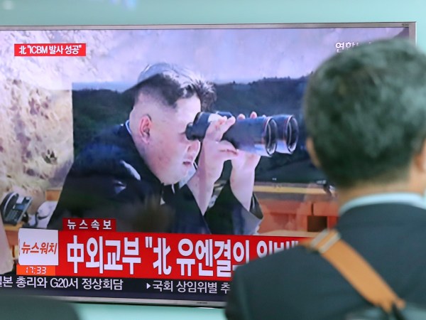 A man walks by a TV screen showing a news program reporting about North Korea's missile firing with an image of North Korean leader Kim Jong Un, at Seoul Train Station in Seoul, South Korea, Tuesday, July 4, 2017. North Korea on Tuesday claimed it successfully test-launched its first intercontinental ballistic missile, a potential game-changing development in what may be the world's most dangerous nuclear standoff and, if true, a direct rebuke to U.S. President Donald Trump's earlier declaration that such a test "won't happen!" (AP Photo/Lee Jin-man)