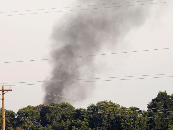 Smoke comes from the wreckage of a military refueling tanker aircraft  that crashed in a soybean field near Itta Bena, Miss., on the western edge of Leflore County, is seen from U.S. Highway 82, Monday, July 10, 2017. Authorities report at least five people were killed. (AP Photo/Andy Lo)