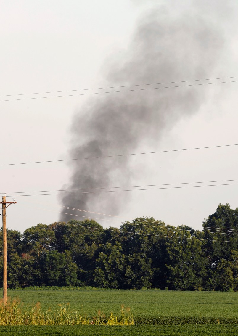 Smoke comes from the wreckage of a military refueling tanker aircraft  that crashed in a soybean field near Itta Bena, Miss., on the western edge of Leflore County, is seen from U.S. Highway 82, Monday, July 10, 2017. Authorities report at least five people were killed. (AP Photo/Andy Lo)