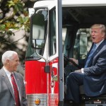 President Donald Trump, accompanied by Vice President Mike Pence, sits inside a cabin of a firetruck during a "Made in America," product showcase featuring items created in each of the U.S. 50 states, Monday, July 17, 2017, on the South Lawn of the White House in Washington. (AP Photo/Pablo Martinez Monsivais)