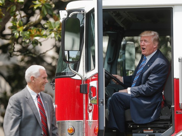 President Donald Trump, accompanied by Vice President Mike Pence, sits inside a cabin of a firetruck during a "Made in America," product showcase featuring items created in each of the U.S. 50 states, Monday, July 17, 2017, on the South Lawn of the White House in Washington. (AP Photo/Pablo Martinez Monsivais)