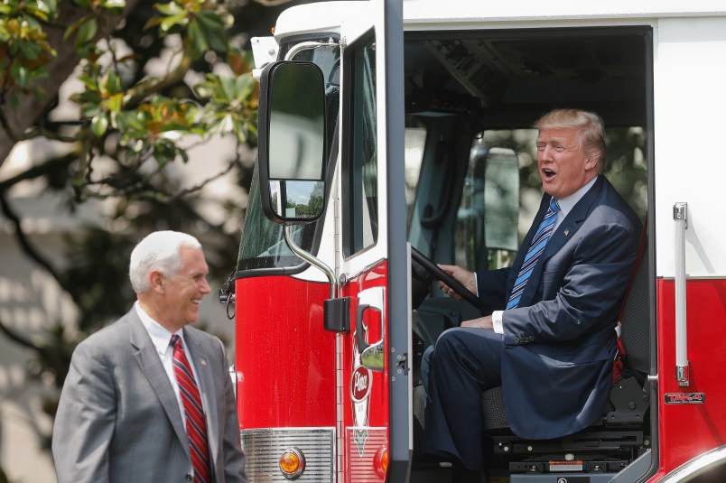 President Donald Trump, accompanied by Vice President Mike Pence, sits inside a cabin of a firetruck during a "Made in America," product showcase featuring items created in each of the U.S. 50 states, Monday, July 17, 2017, on the South Lawn of the White House in Washington. (AP Photo/Pablo Martinez Monsivais)