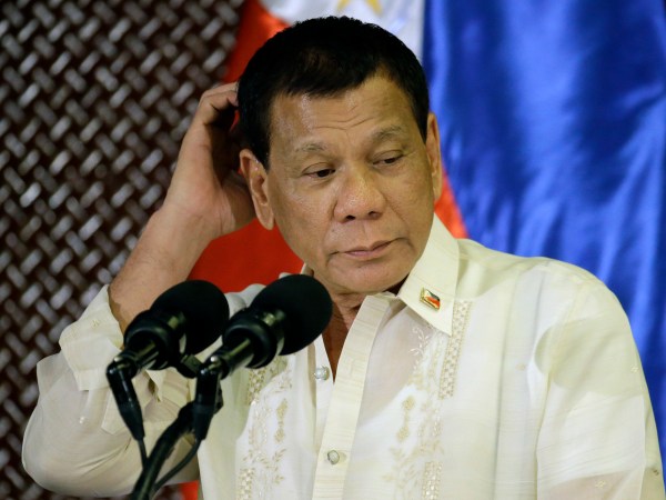 Philippine President Rodrigo Duterte scratches his head during his speech at the ceremonial turnover to the Armed Forces of the Philippines at the Malacanang presidential palace in Manila, Philippines Tuesday, July 18, 2017. Duterte asked Congress on Tuesday to extend martial law in the southern third of the country until the end of the year, saying the rebellion there will not be quelled by July 22, the end of his 60-day martial law proclamation.(AP Photo/Aaron Favila)