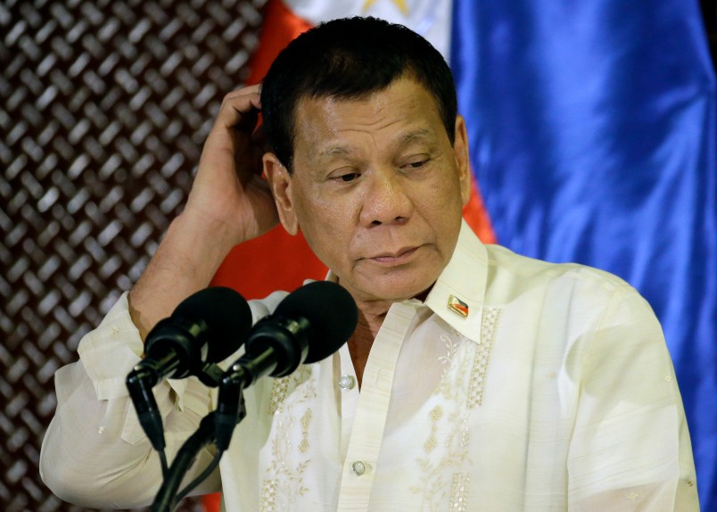 Philippine President Rodrigo Duterte scratches his head during his speech at the ceremonial turnover to the Armed Forces of the Philippines at the Malacanang presidential palace in Manila, Philippines Tuesday, July 18, 2017. Duterte asked Congress on Tuesday to extend martial law in the southern third of the country until the end of the year, saying the rebellion there will not be quelled by July 22, the end of his 60-day martial law proclamation.(AP Photo/Aaron Favila)