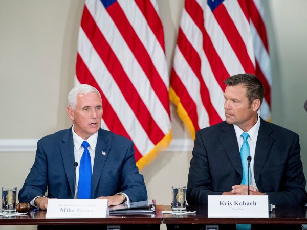 Vice President Mike Pence, left, accompanied by Vice-Char Kansas Secretary of State Kris Kobach, right, speaks during the first meeting of the Presidential Advisory Commission on Election Integrity at the Eisenhower Executive Office Building on the White House complex in Washington, Wednesday, July 19, 2017. (AP Photo/Andrew Harnik)