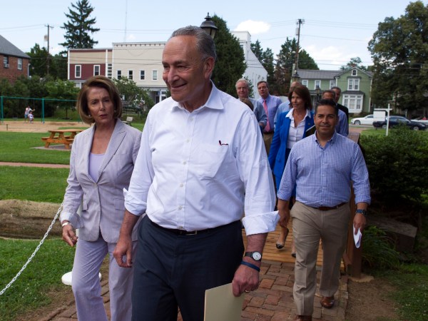 Senate Minority Leader Chuck Schumer of N.Y. and House Minority Leader Nancy Pelosi of Calif. lead Congressional Democrats to a news conference to unveil their new agenda, Monday, July 24, 2017, in Berryville, Va. House and Senate Democrats are offering a retooled message and populist agenda, promising to working Americans "someone has your back."  (AP Photo/Cliff Owen)