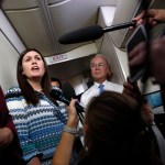 White House press secretary Sarah Huckabee Sanders, joined by Secretary of Health and Human Services Tom Price, speaks to media aboard Air Force One, Monday, July 24, 2017, in Andrews Air Force Base, Md., en route to the 2017 National Scout Jamboree in Glen Jean, W.Va. (AP Photo/Carolyn Kaster)