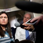 White House press secretary Sarah Huckabee Sanders, joined by Secretary of Health and Human Services Tom Price, listens to reporters questions as she speaks to media aboard Air Force One, Monday, July 24, 2017, in Andrews Air Force Base, Md., en route to the 2017 National Scout Jamboree in Glen Jean, W.Va. (AP Photo/Carolyn Kaster)