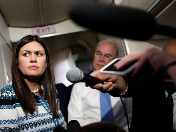 White House press secretary Sarah Huckabee Sanders, joined by Secretary of Health and Human Services Tom Price, listens to reporters questions as she speaks to media aboard Air Force One, Monday, July 24, 2017, in Andrews Air Force Base, Md., en route to the 2017 National Scout Jamboree in Glen Jean, W.Va. (AP Photo/Carolyn Kaster)