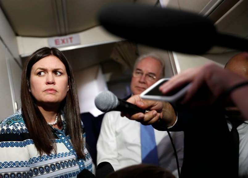 White House press secretary Sarah Huckabee Sanders, joined by Secretary of Health and Human Services Tom Price, listens to reporters questions as she speaks to media aboard Air Force One, Monday, July 24, 2017, in Andrews Air Force Base, Md., en route to the 2017 National Scout Jamboree in Glen Jean, W.Va. (AP Photo/Carolyn Kaster)