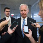 Sen. Ron Johnson, R-Wisc., center, who has expressed opposition to his own party's health care bill, walks to a policy meeting as the Senate Republican legislation teeters on the brink of collapse, at the Capitol in Washington, Tuesday, June 27, 2017. Senate Majority Leader Mitch McConnell, R-Ky., needs 50 members of his conference to back the GOP health care bill in order to pass it but a new Congressional Budget Office analysis imperils the legislation, complicating GOP leaders' hopes of pushing the plan through the chamber this week. (AP Photo/J. Scott Applewhite)