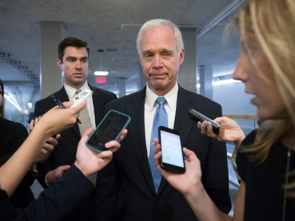 Sen. Ron Johnson, R-Wisc., center, who has expressed opposition to his own party's health care bill, walks to a policy meeting as the Senate Republican legislation teeters on the brink of collapse, at the Capitol in Washington, Tuesday, June 27, 2017. Senate Majority Leader Mitch McConnell, R-Ky., needs 50 members of his conference to back the GOP health care bill in order to pass it but a new Congressional Budget Office analysis imperils the legislation, complicating GOP leaders' hopes of pushing the plan through the chamber this week. (AP Photo/J. Scott Applewhite)