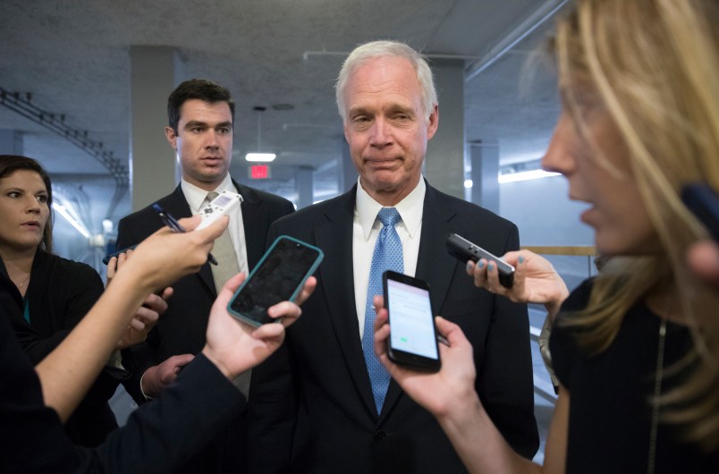 Sen. Ron Johnson, R-Wisc., center, who has expressed opposition to his own party's health care bill, walks to a policy meeting as the Senate Republican legislation teeters on the brink of collapse, at the Capitol in Washington, Tuesday, June 27, 2017. Senate Majority Leader Mitch McConnell, R-Ky., needs 50 members of his conference to back the GOP health care bill in order to pass it but a new Congressional Budget Office analysis imperils the legislation, complicating GOP leaders' hopes of pushing the plan through the chamber this week. (AP Photo/J. Scott Applewhite)