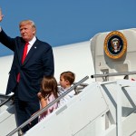 President Donald Trump waves as he walks down the steps of Air Force One with his grandchildren, Arabella Kushner, center, and Joseph Kushner, right, after arriving at Morristown Municipal Airport to begin his summer vacation at his Bedminster golf club, Friday, Aug. 4, 2017, in Morristown, N.J. (AP Photo/Evan Vucci)