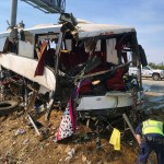 FILE--In this Aug. 2, 2016. file photo, authorities investigate the scene of a charter bus crash on northbound Highway 99 between Atwater and Livingston, Calif.,  The Merced County District Attorney’s office on Monday, July 31, 2017, filed four felony counts of vehicular manslaughter and five misdemeanor vehicle code violations against Mario David Vasquez in connection with a bus crash last August amid San Joaquin Valley farmland. (AP Photo/Scott Smith, file)