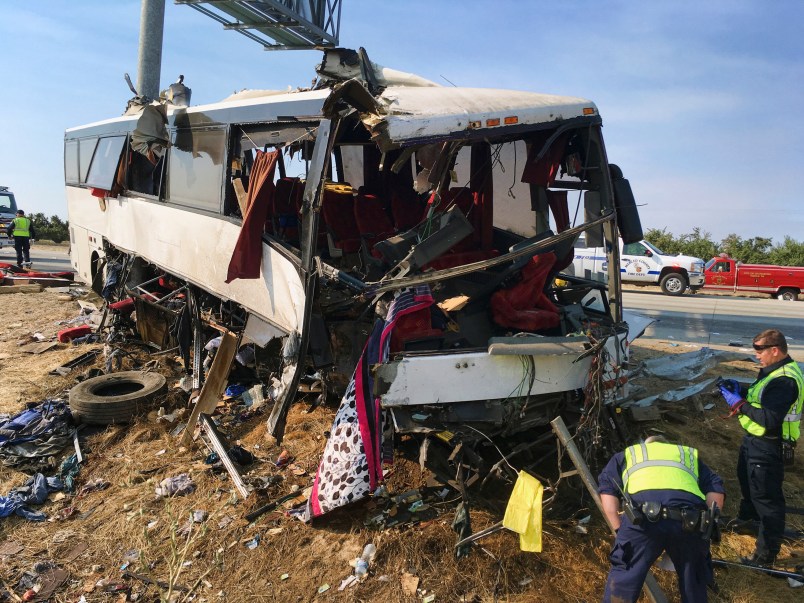 FILE--In this Aug. 2, 2016. file photo, authorities investigate the scene of a charter bus crash on northbound Highway 99 between Atwater and Livingston, Calif.,  The Merced County District Attorney’s office on Monday, July 31, 2017, filed four felony counts of vehicular manslaughter and five misdemeanor vehicle code violations against Mario David Vasquez in connection with a bus crash last August amid San Joaquin Valley farmland. (AP Photo/Scott Smith, file)