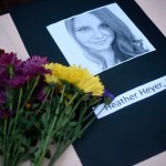 A portrait of Heather Heyer, who was killed when a vehicle drove through counter protestors in Charlottesville, Va., lies on on a table with flowers at the Vigil Against Hate held on the campus of the University of Southern Mississippi in solidarity with the counter protesters killed and injured against the White Nationalists in Charlottesville, Va., in Hattiesburg, Miss. Monday, Aug 14, 2017 (Courtland Wells | Vicksburg Post, via AP)