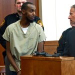 FILE – In this Feb. 25, 2015, file photo, Abdirahman Sheik Mohamud, front left, speaks with his attorney Sam Shamansky, right, during a hearing to set bond in Columbus, Ohio. Mohamud pleaded guilty to terrorism charges in 2015 and is asking for leniency at his Friday, Aug. 18, 2017, sentencing, saying he abandoned his plan to kill military members in the U.S., Shamansky said in a Monday, Aug. 14, 2017, court filing. (AP Photo/Andrew Welsh-Huggins, File)