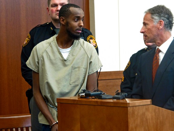 FILE – In this Feb. 25, 2015, file photo, Abdirahman Sheik Mohamud, front left, speaks with his attorney Sam Shamansky, right, during a hearing to set bond in Columbus, Ohio. Mohamud pleaded guilty to terrorism charges in 2015 and is asking for leniency at his Friday, Aug. 18, 2017, sentencing, saying he abandoned his plan to kill military members in the U.S., Shamansky said in a Monday, Aug. 14, 2017, court filing. (AP Photo/Andrew Welsh-Huggins, File)