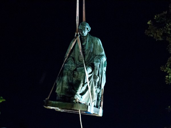 Workers lift with a crane the monument dedicated to U.S. Supreme Court Chief Justice Roger Brooke Taney, after was remove from the outside Maryland State House, in Annapolis, Md., early Friday, Aug. 18, 2017. Maryland workers hauled several monuments away, days after a white nationalist rally in Charlottesville, Virginia, turned deadly. ( AP Photo/Jose Luis Magana)