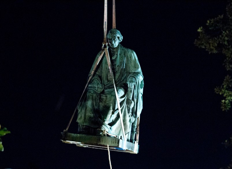 Workers lift with a crane the monument dedicated to U.S. Supreme Court Chief Justice Roger Brooke Taney, after was remove from the outside Maryland State House, in Annapolis, Md., early Friday, Aug. 18, 2017. Maryland workers hauled several monuments away, days after a white nationalist rally in Charlottesville, Virginia, turned deadly. ( AP Photo/Jose Luis Magana)