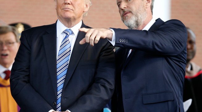 President Donald Trump stands with Liberty University president, Jerry Falwell Jr., right, during commencement ceremonies at the school in Lynchburg, Va., Saturday, May 13, 2017. (AP Photo/Steve Helber)