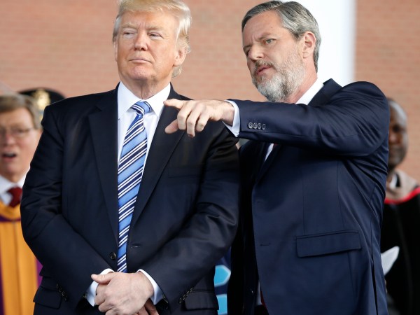 President Donald Trump stands with Liberty University president, Jerry Falwell Jr., right, during commencement ceremonies at the school in Lynchburg, Va., Saturday, May 13, 2017. (AP Photo/Steve Helber)
