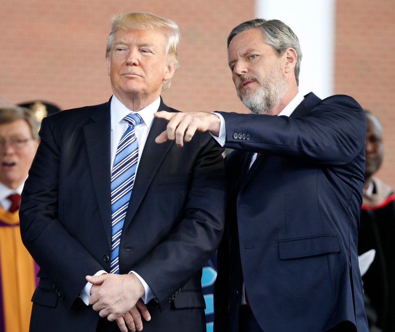 President Donald Trump stands with Liberty University president, Jerry Falwell Jr., right, during commencement ceremonies at the school in Lynchburg, Va., Saturday, May 13, 2017. (AP Photo/Steve Helber)