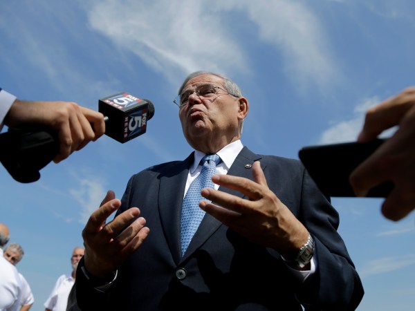 U.S. Sen. Bob Menendez, center, takes questions after news conference talking about flood insurance, Thursday, Aug. 17, 2017, in Union Beach, N.J. Menendez and Rep. Frank Pallone, far right, want changes made to federal flood insurance they said will fix a system that often failed beleaguered homeowners, including in the aftermath of Superstorm Sandy. The two Democrats described legislation they have proposed that will reauthorize a 2012 flood insurance bill scheduled to expire next month and add key provisions. After the press conference, Menenedez fielded questions about his upcoming trial in which he is facing federal corruption charges. (AP Photo/Julio Cortez)
