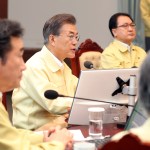 South Korean President Moon Jae-in, center, presides over a cabinet meeting at the presidential Blue House in Seoul, South Korea, Monday, Aug. 21, 2017. U.S. and South Korean troops have begun annual drills that come after tensions rose over North Korea's two intercontinental ballistic missile tests last month. South Korea's President Moon Jae-in said Monday the drills are defensive in nature. He says the drills are held regularly because of repeated provocations by North Korea. (Kim Ju-hyung/Yonhap via AP)