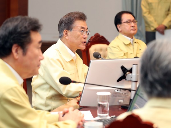 South Korean President Moon Jae-in, center, presides over a cabinet meeting at the presidential Blue House in Seoul, South Korea, Monday, Aug. 21, 2017. U.S. and South Korean troops have begun annual drills that come after tensions rose over North Korea's two intercontinental ballistic missile tests last month. South Korea's President Moon Jae-in said Monday the drills are defensive in nature. He says the drills are held regularly because of repeated provocations by North Korea. (Kim Ju-hyung/Yonhap via AP)