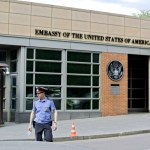 A Russian policeman stands in front of  an entrance of the U.S. Embassy in the background  in downtown Moscow, Russia, on Tuesday, May 14, 2013. Russia’s security services said Tuesday that they detained a U.S. diplomat they claim is a CIA agent after they caught him red-handed trying to recruit a Russian agent. (AP Photo/Ivan Sekretarev)