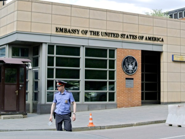 A Russian policeman stands in front of  an entrance of the U.S. Embassy in the background  in downtown Moscow, Russia, on Tuesday, May 14, 2013. Russia’s security services said Tuesday that they detained a U.S. diplomat they claim is a CIA agent after they caught him red-handed trying to recruit a Russian agent. (AP Photo/Ivan Sekretarev)