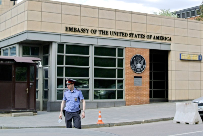 A Russian policeman stands in front of  an entrance of the U.S. Embassy in the background  in downtown Moscow, Russia, on Tuesday, May 14, 2013. Russia’s security services said Tuesday that they detained a U.S. diplomat they claim is a CIA agent after they caught him red-handed trying to recruit a Russian agent. (AP Photo/Ivan Sekretarev)