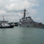 CHANGI NAVAL BASE, REPUBLIC OF SINGAPORE – Tugboats from Singapore assist the Guided-missile destroyer USS John S. McCain (DDG 56) as it steers towards Changi Naval Base, Republic of Singapore following a collision with the merchant vessel Alnic MC while underway east of the Straits of Malacca and Singapore on Aug. 21. Significant damage to the hull resulted in flooding to nearby compartments, including crew berthing, machinery, and communications rooms. Damage control efforts by the crew halted further flooding. The incident will be investigated. (U.S. Navy photo by Mass Communication Specialist 2nd Class Joshua Fulton/Released)